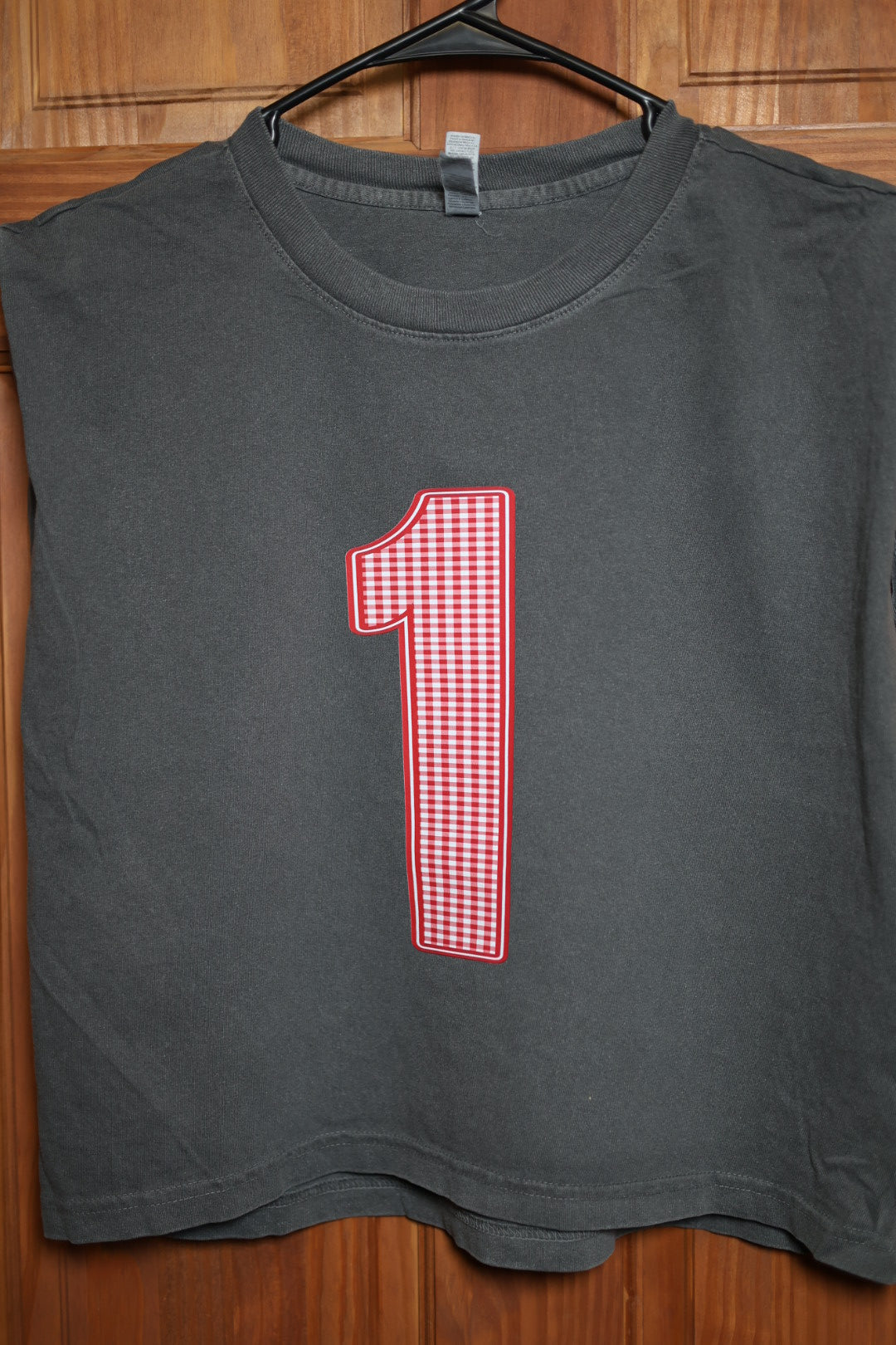 Charcoal gray muscle tank featuring a custom red and white gingham varsity number 1 centered on the front.
