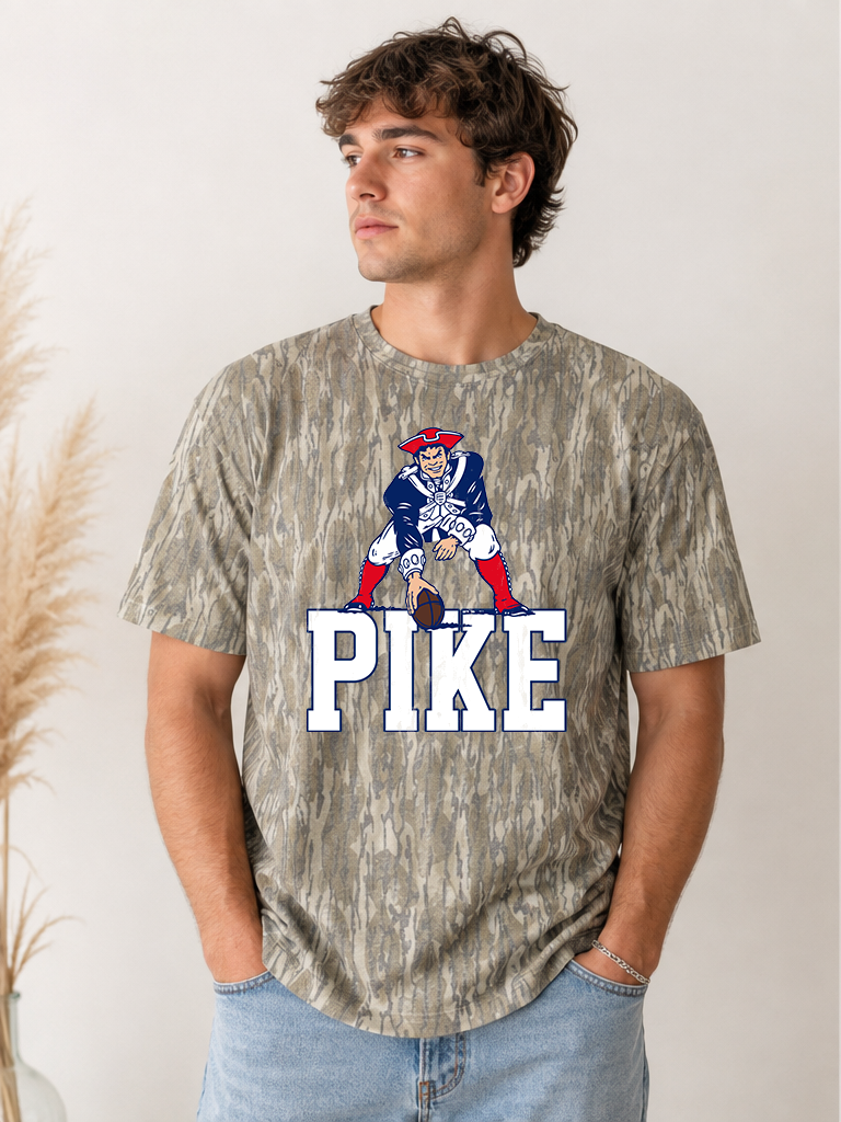 Camo t-shirt with Pike Block Lettters (white text, navy outline) and Vintage Patriots football player on top of text.