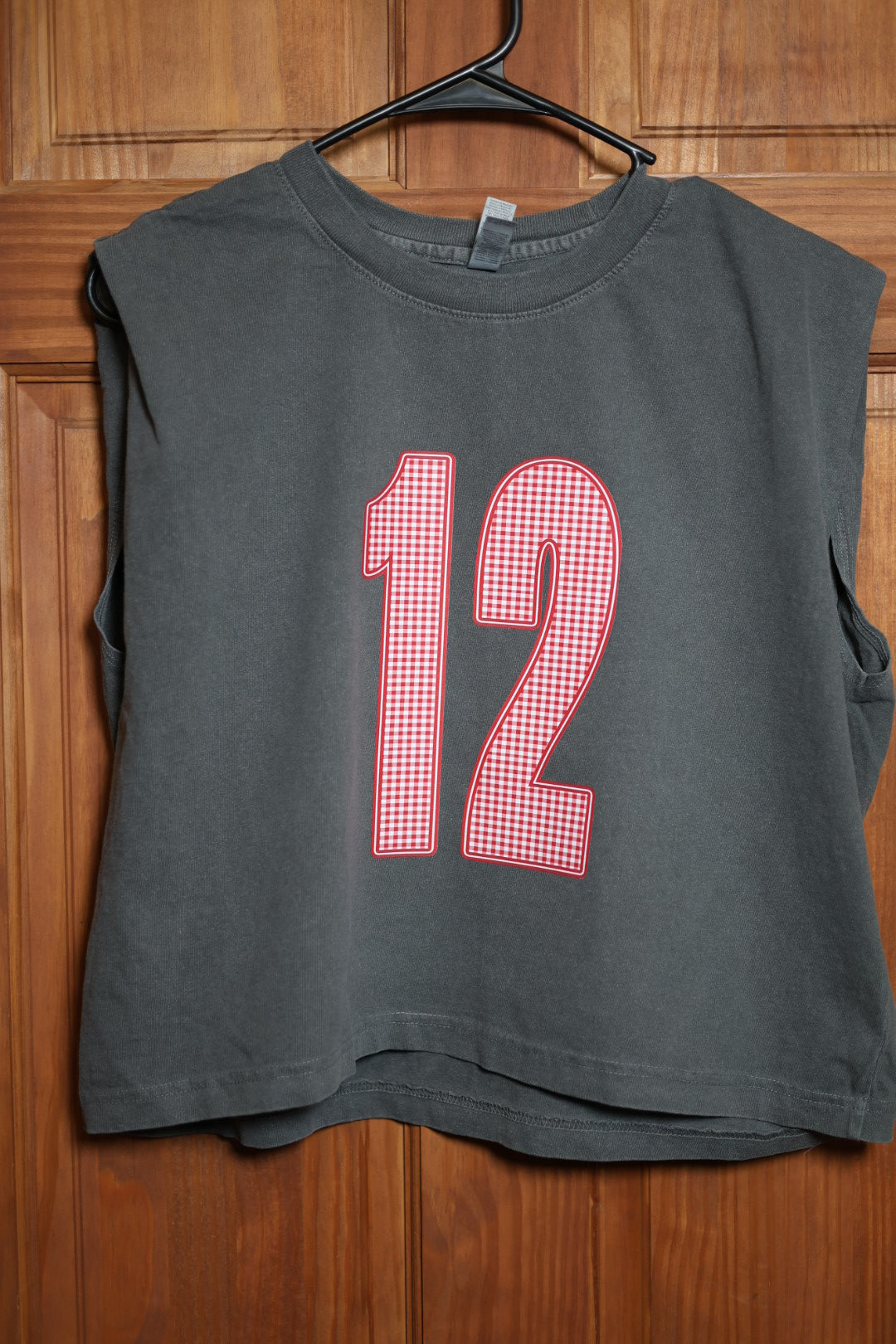 Charcoal gray muscle tank featuring a red and white gingham varsity number 12 with red and white outline.
