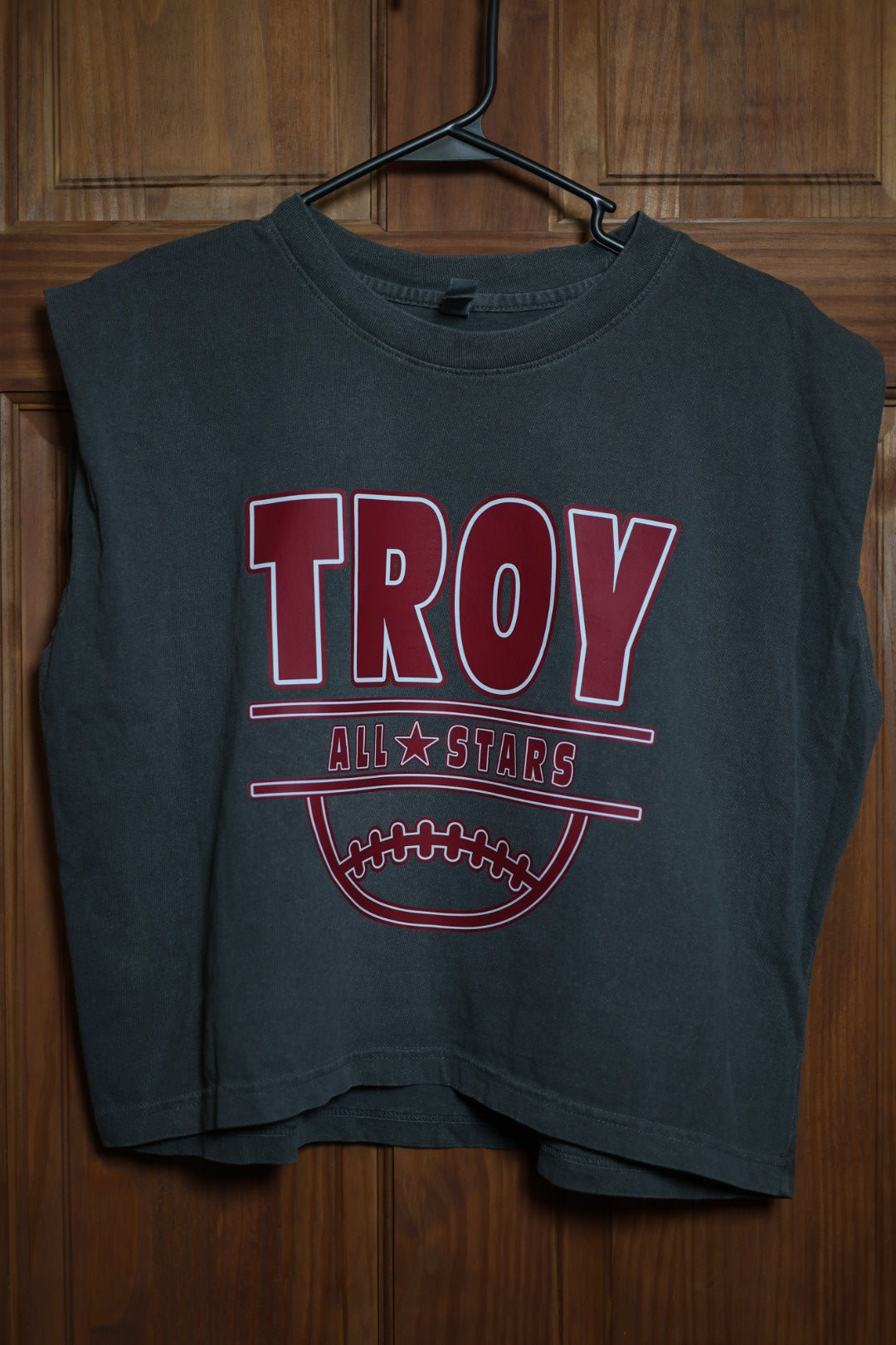 Charcoal gray muscle tank featuring a cardinal red Troy All Stars baseball design with varsity lettering and baseball graphic.
