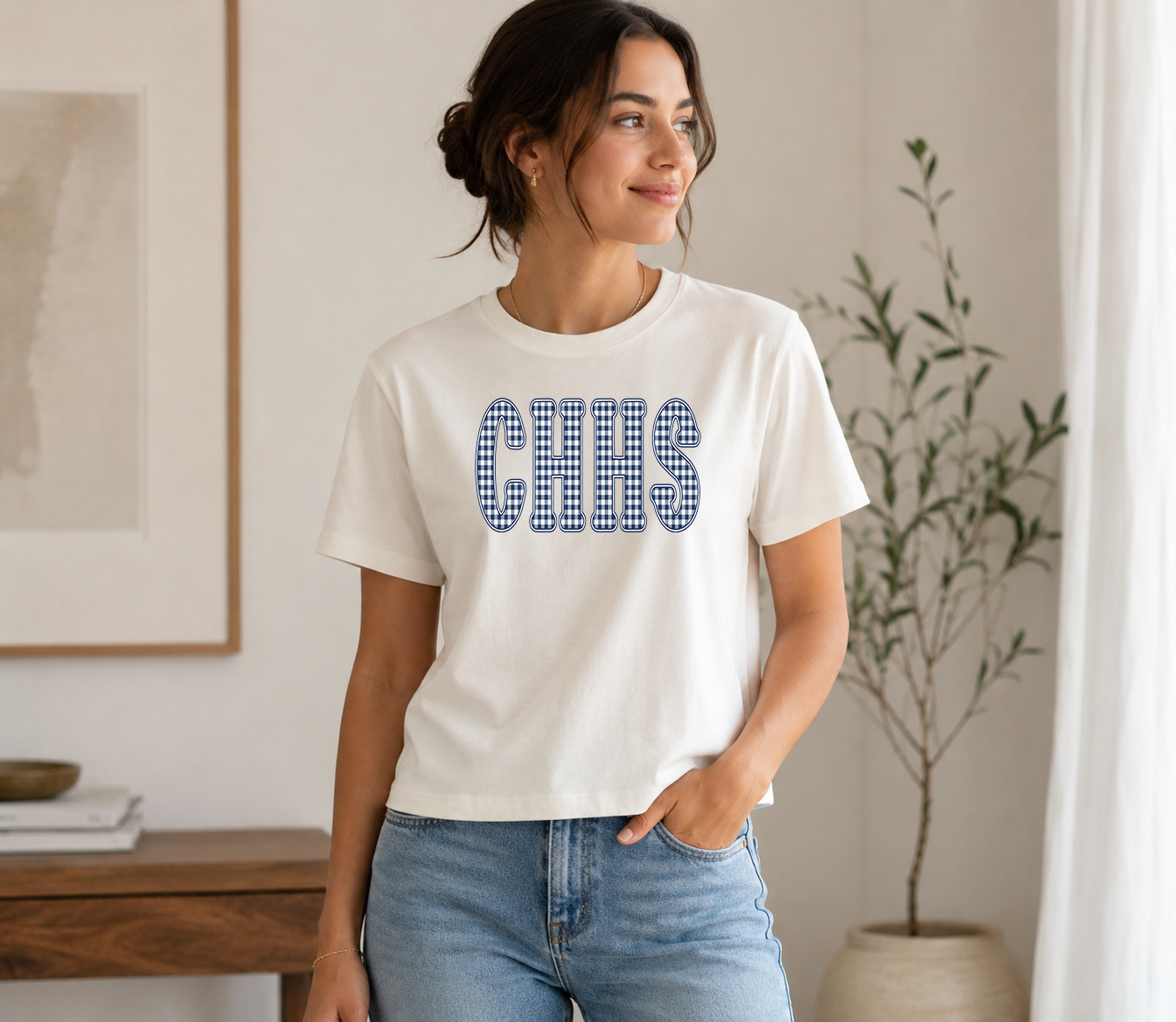 Woman wearing a vintage white t-shirt with a navy gingham CHHS design