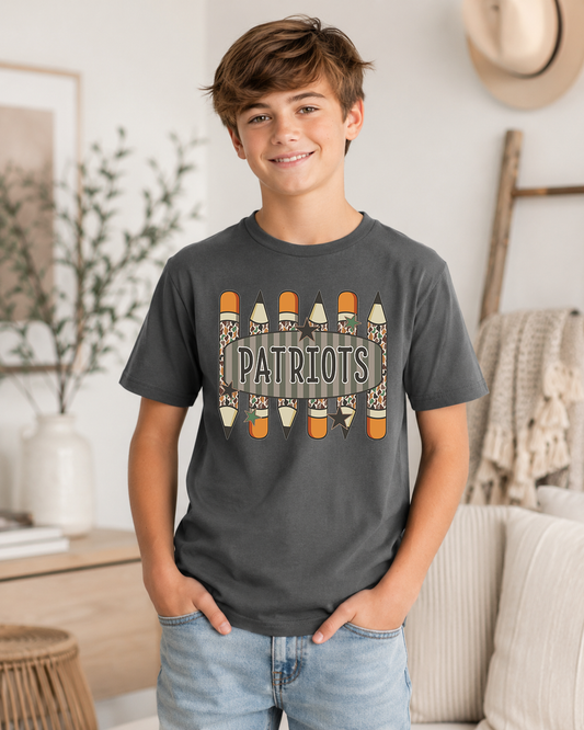 Custom school spirit t-shirt featuring camo pencils, vintage striped background, stars, and personalized school name in school colors.