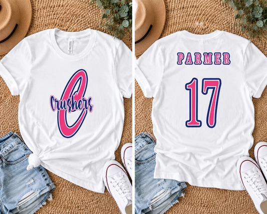 White boutique-style t-shirt featuring a pink and navy Crushers baseball design on the front and custom name and number on the back, styled in a trendy flat lay mockup.
